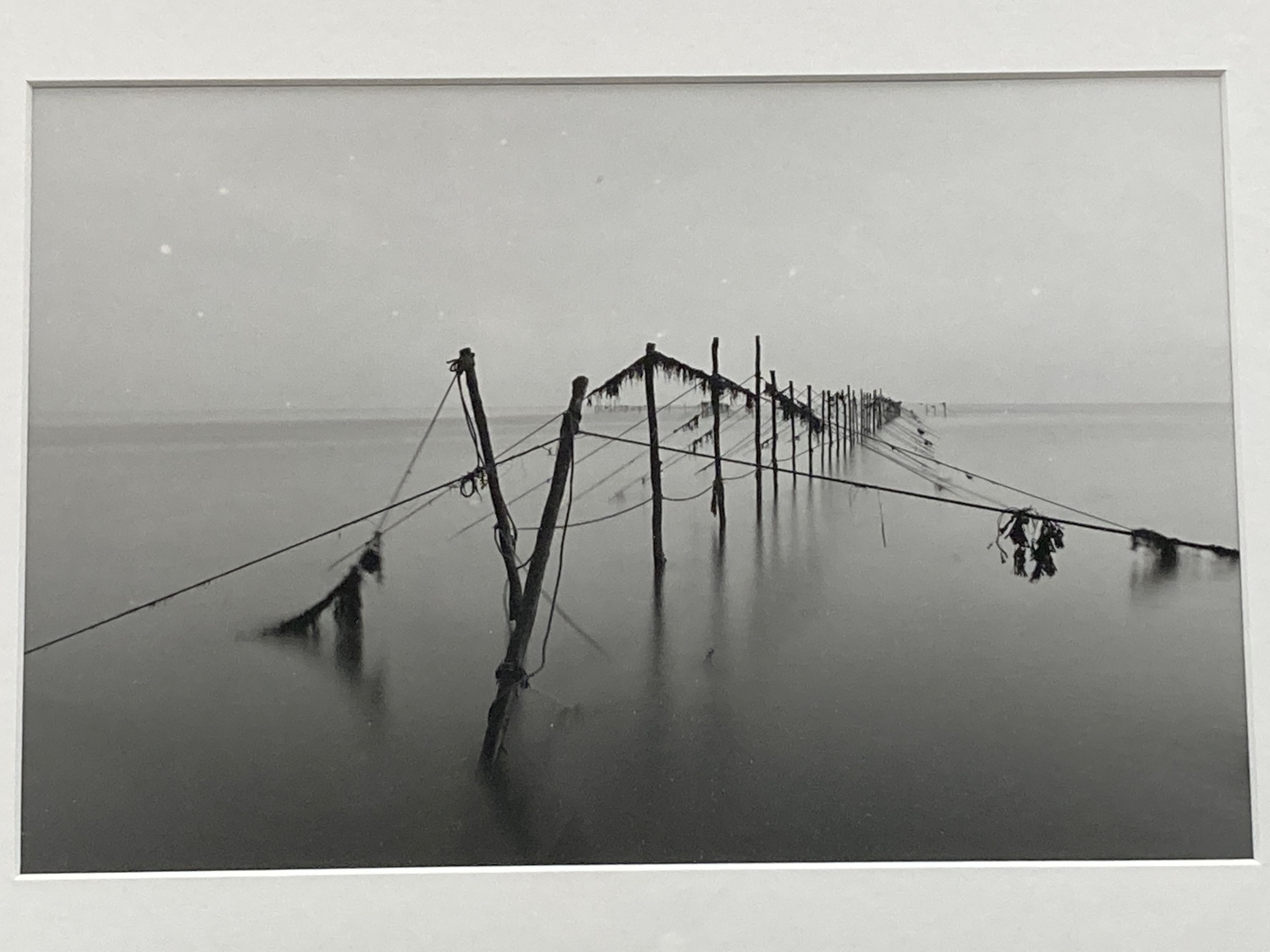 Three framed black and white photographs, North African mosque, Street scene and Fish traps, largest 26 x 17cm